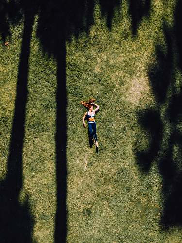 grass woman lying on green grass during daytime plant