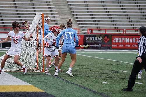 person woman playing lacrosse during daytime people