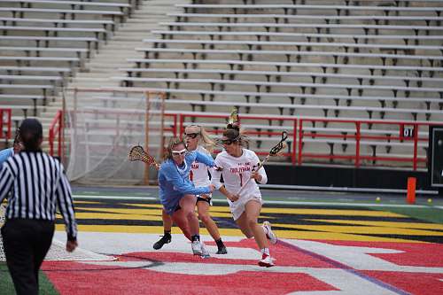 person woman playing lacrosse on stadium sphere