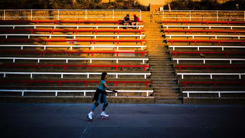 person woman playing roller skates banister