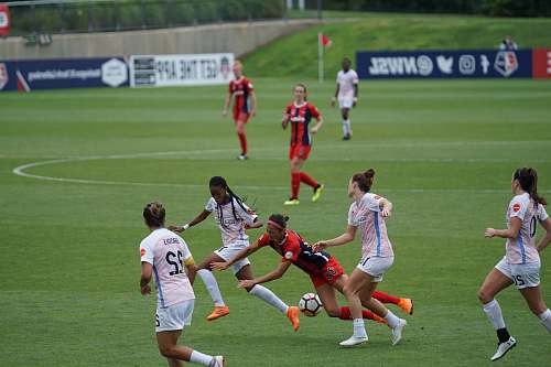 team woman playing soccer on field soccer