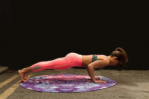 fitness woman pushing up on yoga mat yoga