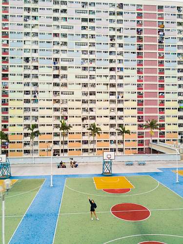 people woman standing on basketball court near hote basketball