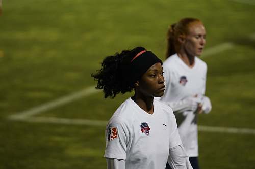 person woman wearing white soccer jersey standing on field clothing