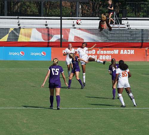 person women playing football during daytime people