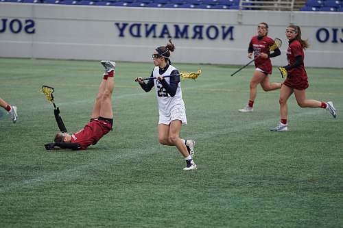 person women playing lacrosse during daytime people