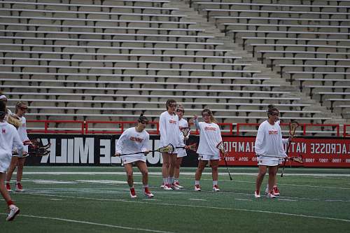 person women playing lacrosse game field