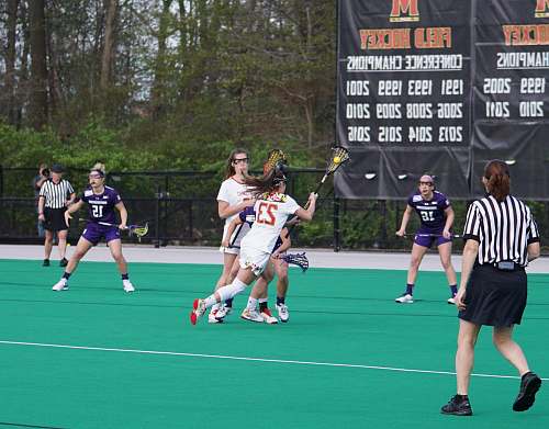 team women playing lacrosse person