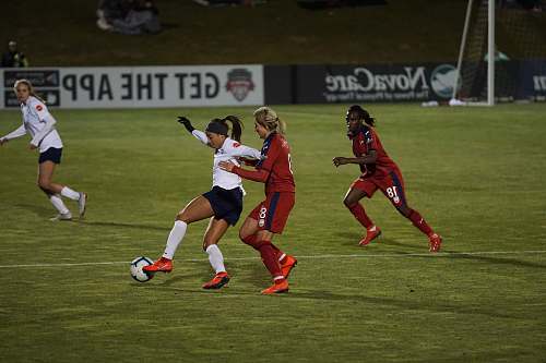 person women playing soccer of grass field people