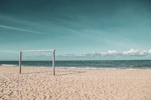 water goalie standing at the sand dunes near seashore shoreline