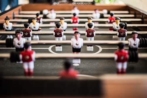 human brown foosball table closeup photography person