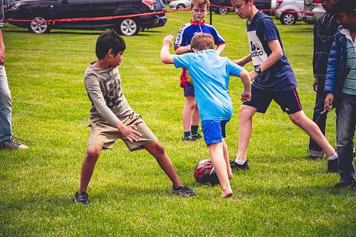 human boy's playing soccer car