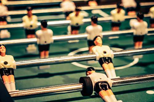 human close up photography of foosball table people