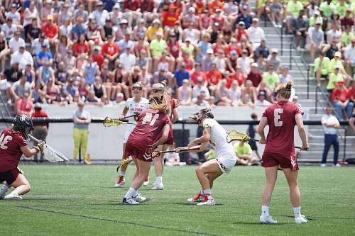 human girl playing lacrosse during daytime people