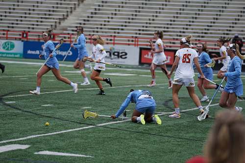 human group of women playing lacrosse during daytime people