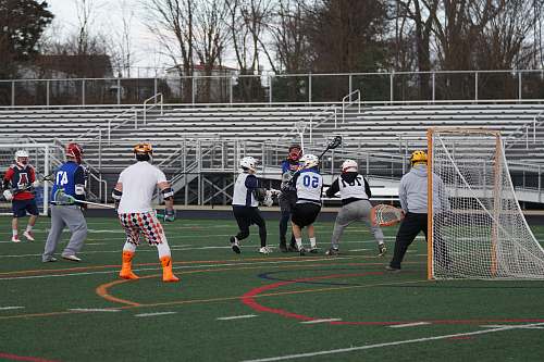 human lacrosse players on field people