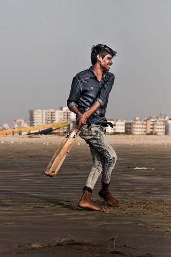 human man holding cricket bat sport