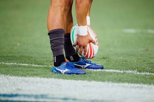 apparel man holding rugby ball clothing