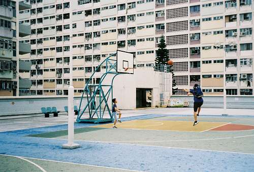 human man plying basketball near outdoor during daytime people