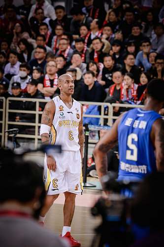 sport man wearing white jersey shirt near man wearing blue jersey shirt basketball