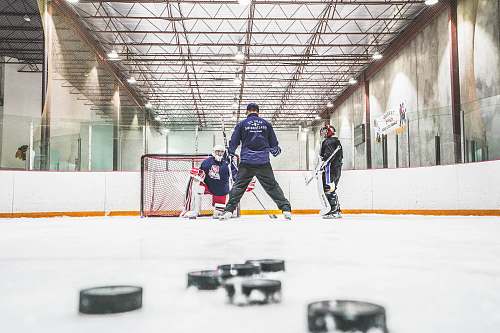 human men playing ice hockey sports