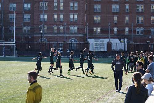 human people playing soccer on the field people