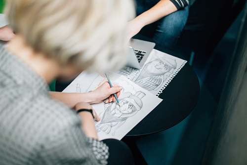 reading person wearing gray shirt sketch working