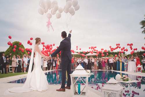 people photo of a man and woman newly wedding holding a balloons wedding
