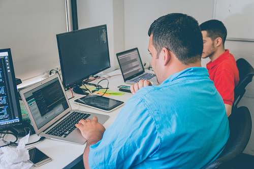 human two men using laptop computer