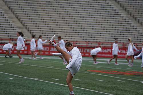 human woman athlete doing exercise on field people