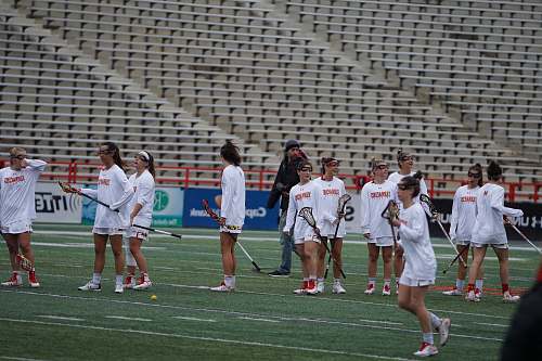 human woman playing lacrosse during daytime people