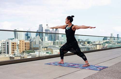 human woman standing on mat raising hands people