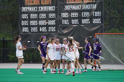 human women playing lacrosse during daytime people