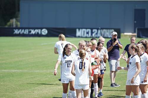 human women standing on soccer field people