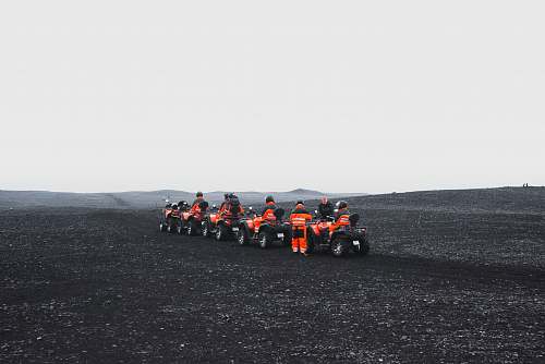 iceland group of people in orange suit riding a ATV black