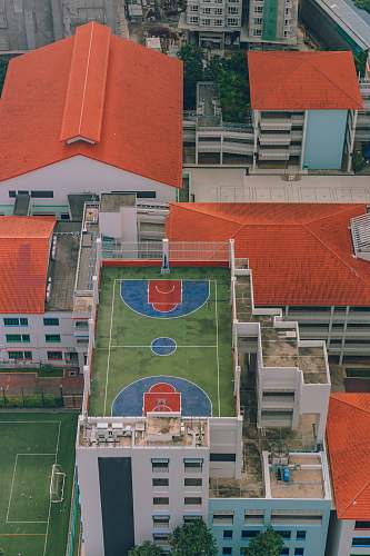 singapore aerial photography of basketball court near houses team sport