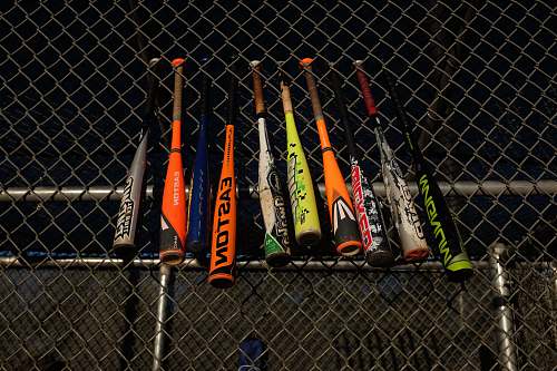 fence baseball bats hanged at the fence of the field baseball