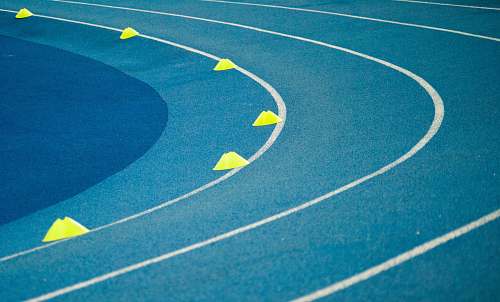 sports blue curved track field at daytime basketball court