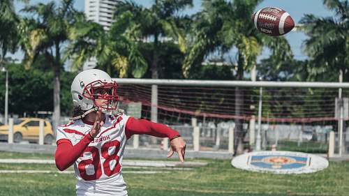 sports football player throwing footbal football
