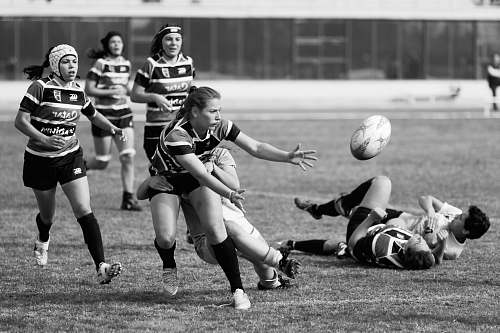 person grayscale photo of a woman playing soccer black-and-white