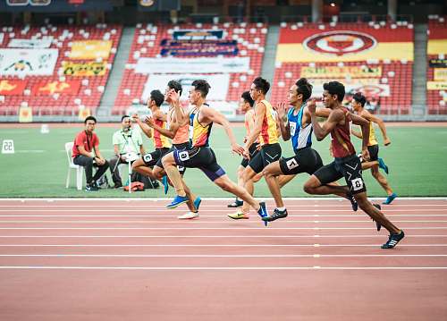 sports group of man running on the field running track