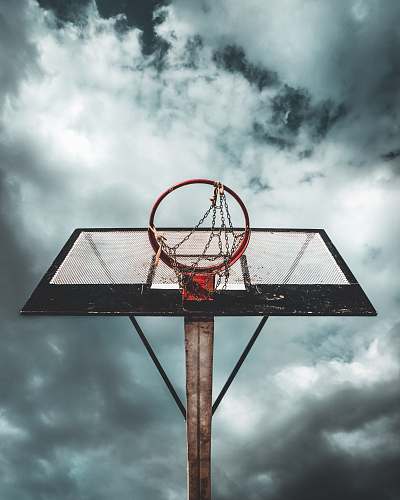 basketball low angle photo of white and black metal portable basketball hoop under cloudy sky during daytime sports