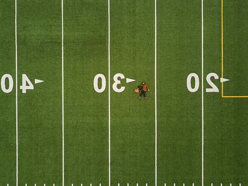 person man lying on 30 yards on football field football