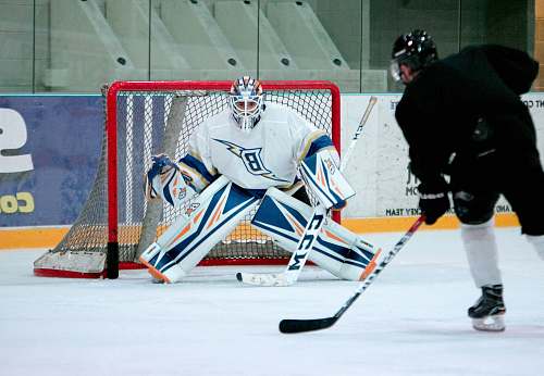 hockey man taking aim for goal on hockey goalie sports