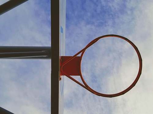 basketball orange and black basketball hoop under white and blue sky basketball court