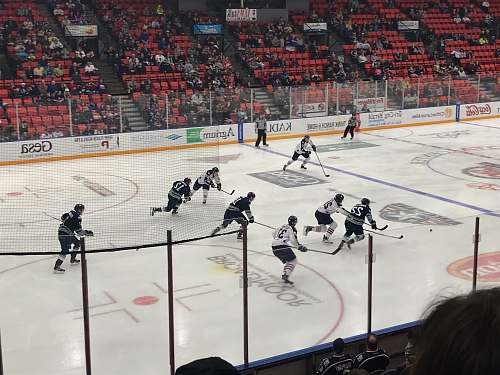 sports people playing ice hockey at the arena hockey
