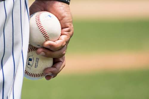 people person holding two baseballs baseball