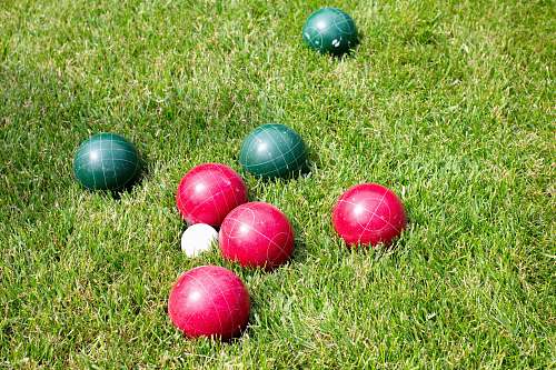sports red and green balls in green field grass