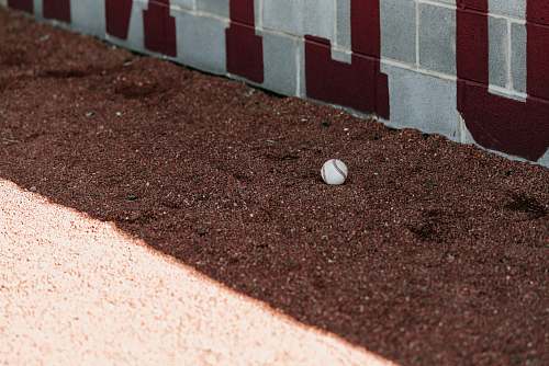 sports white marble toy on soil soil