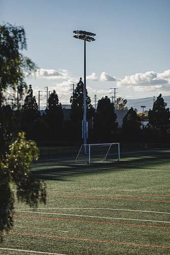 sports white soccer field post lights during daytime team